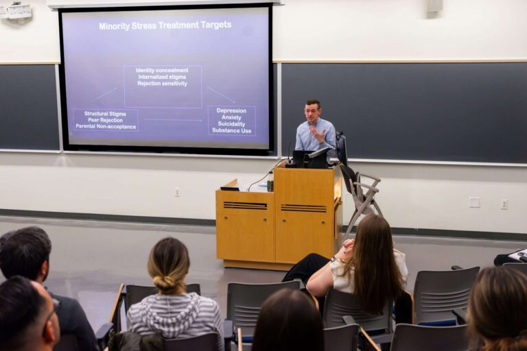Dr. John Pachankis gives a presentation at the front of a classroom during Grand Rounds