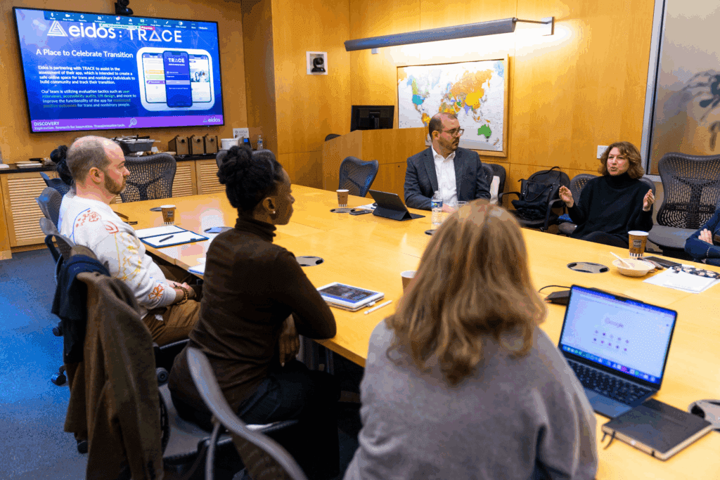 Photo of people meeting around a table in a conference room