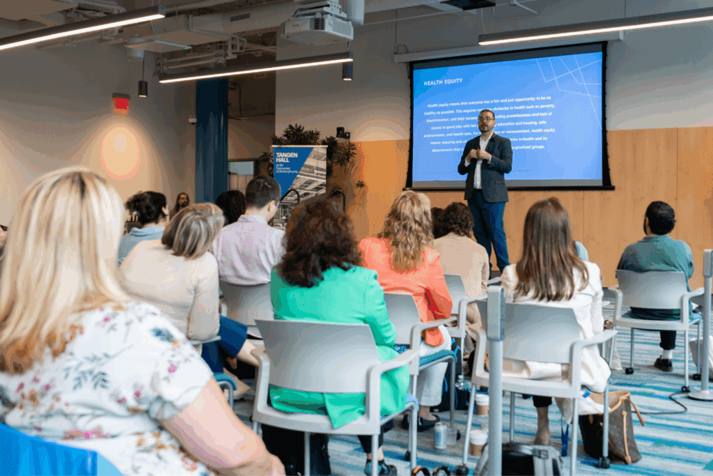 A photo of Dr. Jose Bauermeister giving a talk in front of an audience