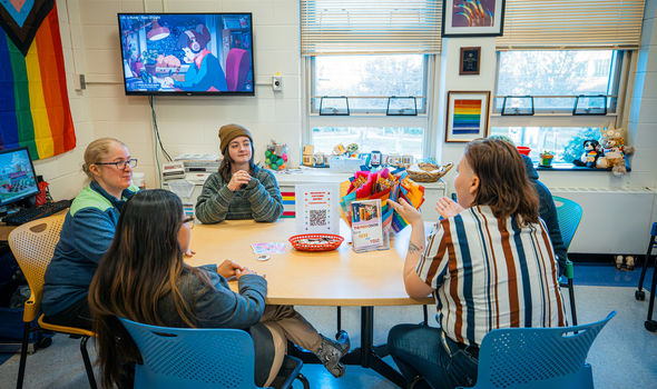 Photo of people gathered around a table together in an LGBT Center